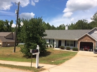 3381 Trotters Ridge Trail Gray, GA 31032 - Photo 2 of 15 a front view of a house with a yard