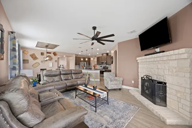 a living room with furniture a fireplace and a flat screen tv