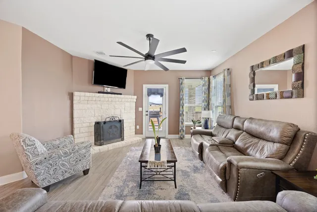a living room with furniture fireplace and flat screen tv