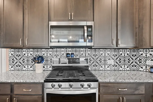 a stove top oven sitting inside of a kitchen