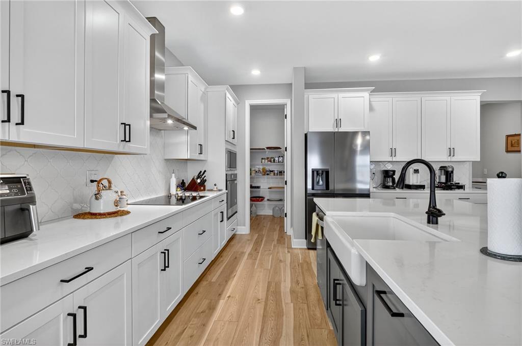2082 Grove Drive Naples, FL 34120 - Photo 12 of 50 a large kitchen with a sink stainless steel appliances and cabinets