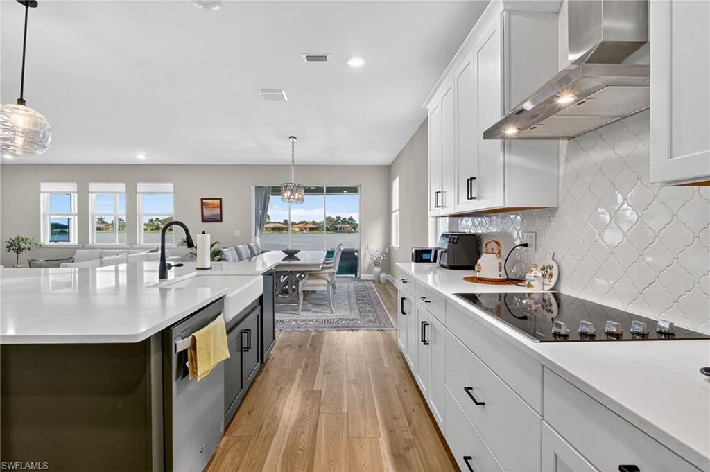 2082 Grove Drive Naples, FL 34120 - Photo 13 of 50 a kitchen with white cabinets and sink