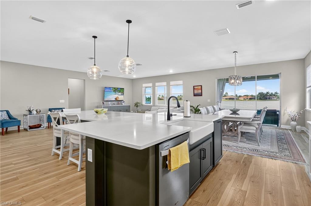 2082 Grove Drive Naples, FL 34120 - Photo 14 of 50 a large kitchen with lots of counter space a sink appliances and dining table