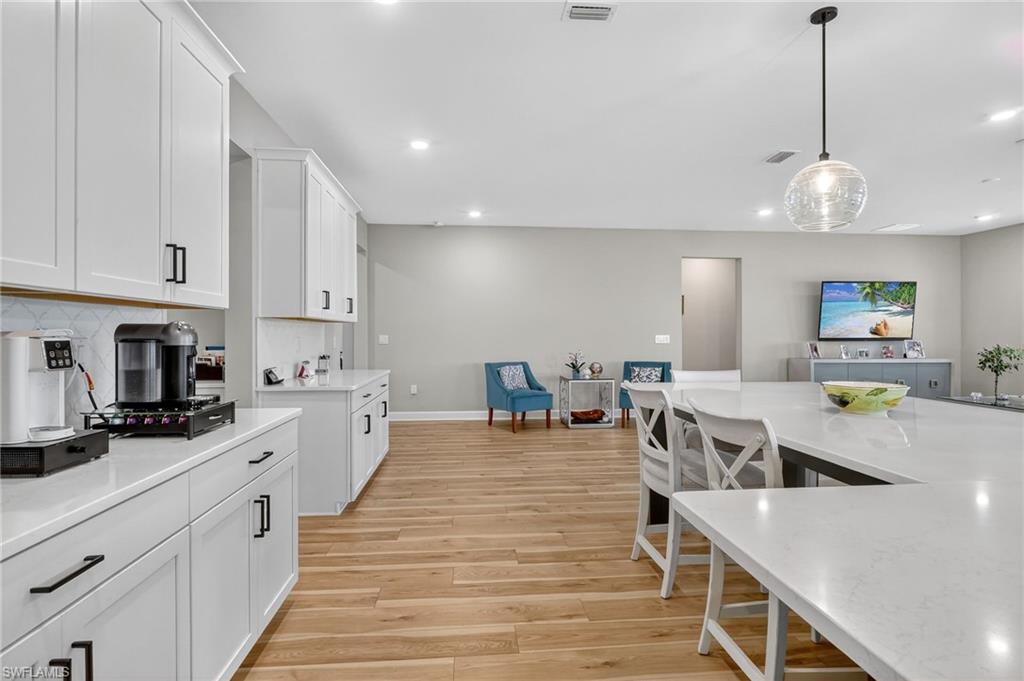 2082 Grove Drive Naples, FL 34120 - Photo 15 of 50 a large kitchen with lots of counter space a sink appliances and cabinets