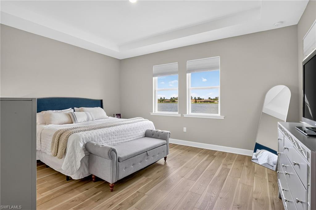 2082 Grove Drive Naples, FL 34120 - Photo 17 of 50 a bedroom with a bed wooden floor and window