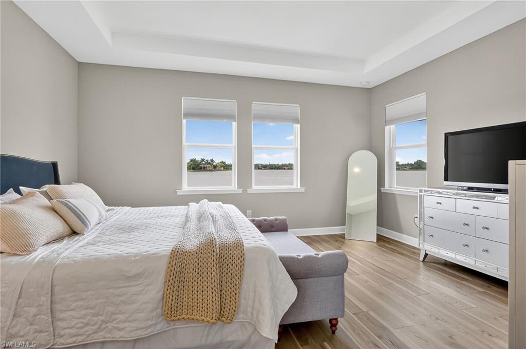 2082 Grove Drive Naples, FL 34120 - Photo 20 of 50 a bedroom with a bed and flat screen tv