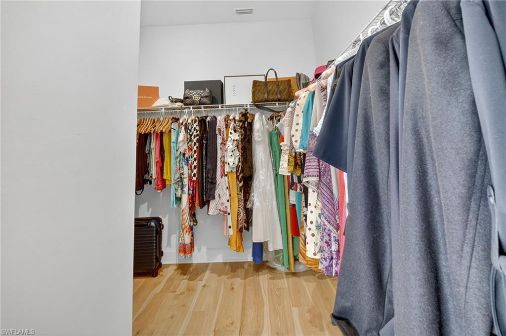 2082 Grove Drive Naples, FL 34120 - Photo 23 of 50 a view of walk in closet with clothes