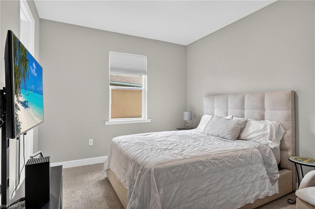 2082 Grove Drive Naples, FL 34120 - Photo 24 of 50 a bedroom with a bed and a window