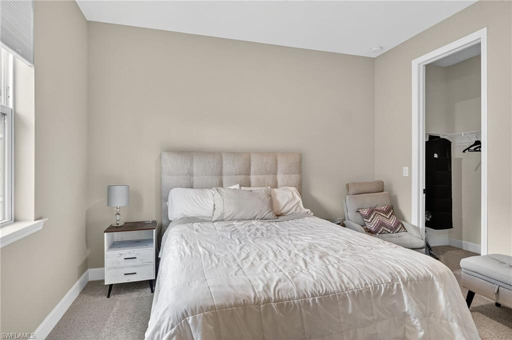 2082 Grove Drive Naples, FL 34120 - Photo 25 of 50 a bedroom with a large bed and a window