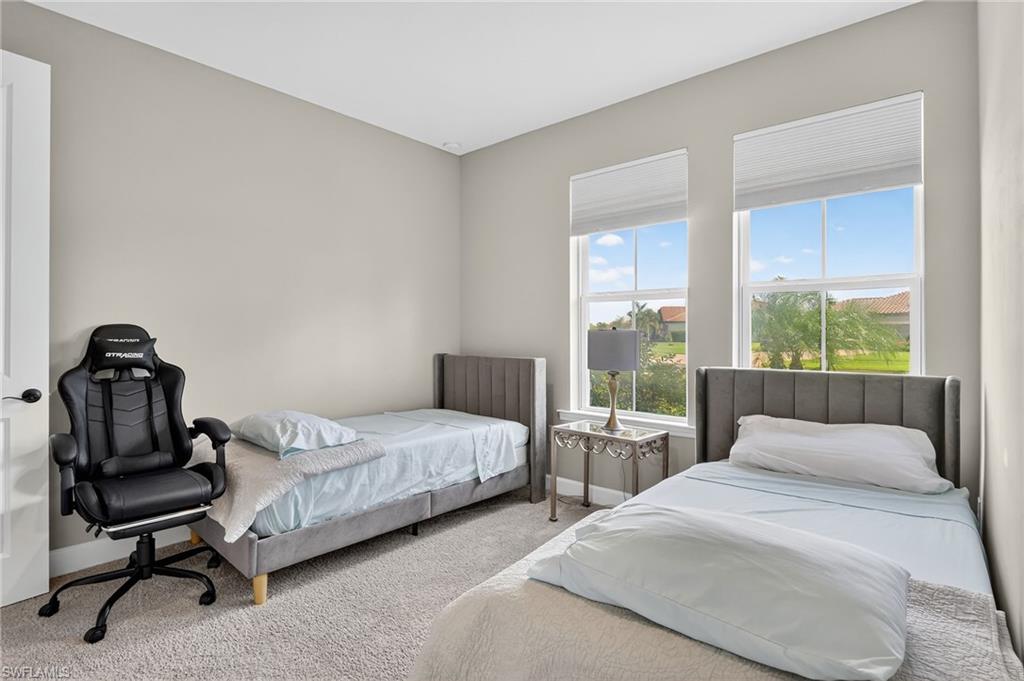 2082 Grove Drive Naples, FL 34120 - Photo 26 of 50 a bedroom with two beds and large windows
