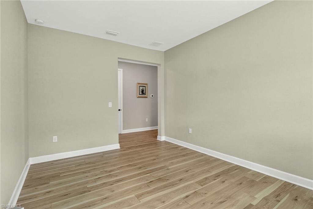 2082 Grove Drive Naples, FL 34120 - Photo 30 of 50 a view of an empty room with wooden floor