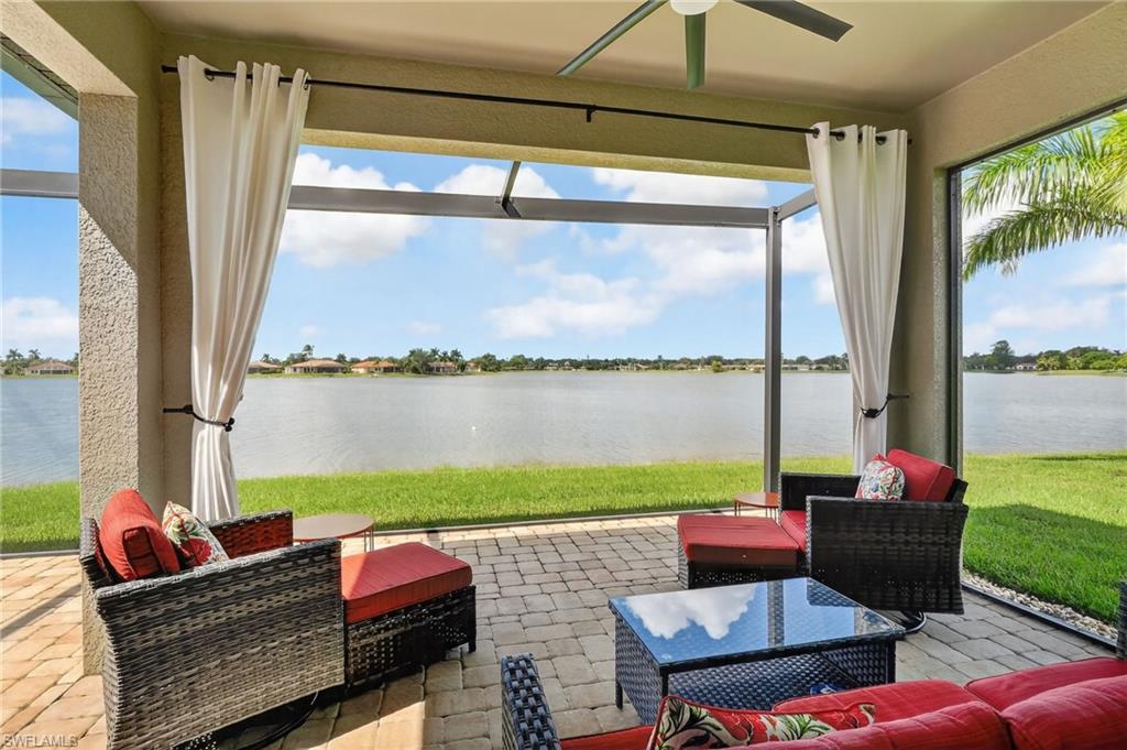 2082 Grove Drive Naples, FL 34120 - Photo 34 of 50 a outdoor living room with furniture and a floor to ceiling window