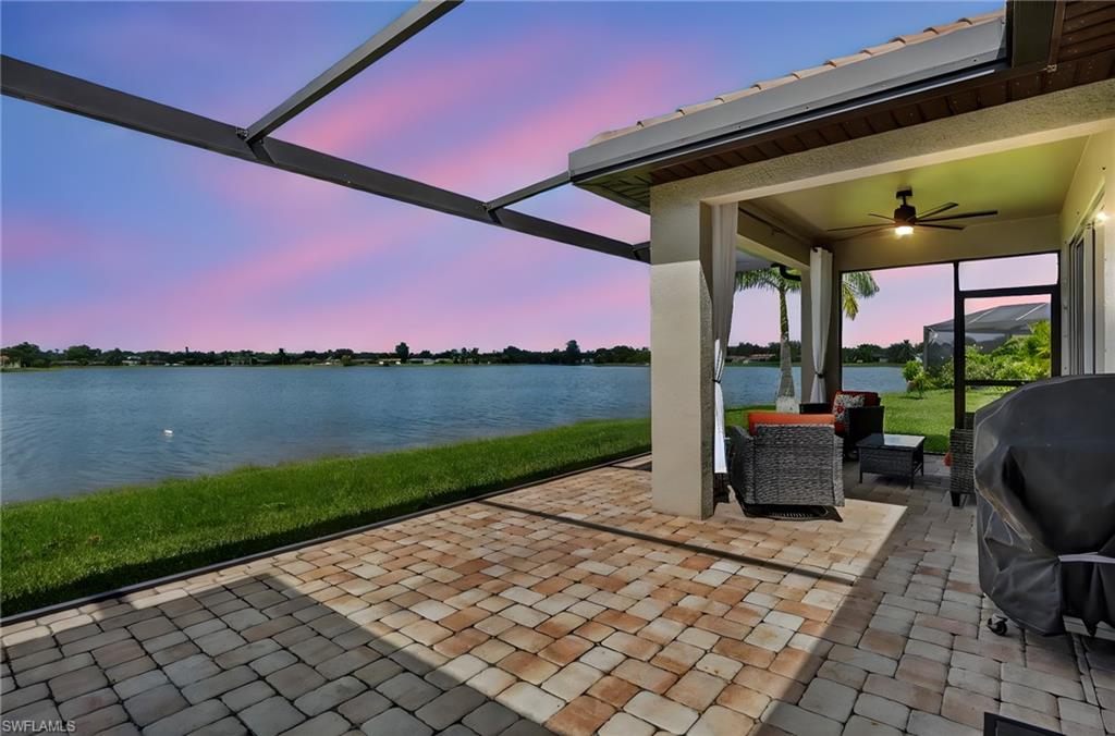 2082 Grove Drive Naples, FL 34120 - Photo 38 of 50 a view of a patio with a table and chairs under an umbrella