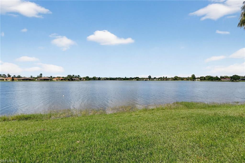 2082 Grove Drive Naples, FL 34120 - Photo 39 of 50 a view of a lake with houses in the back