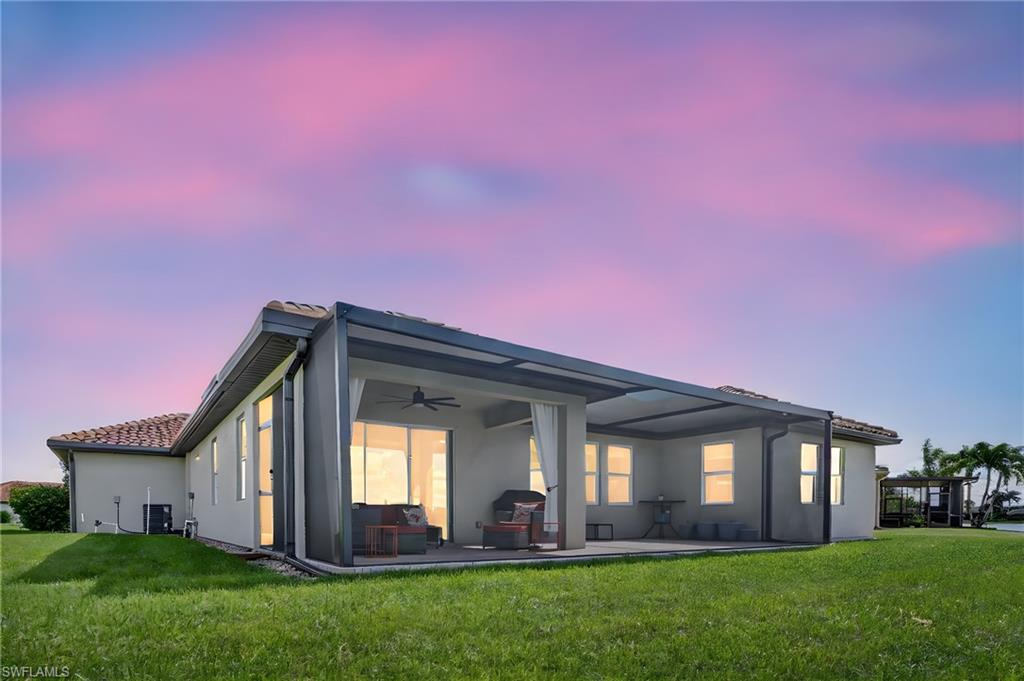 2082 Grove Drive Naples, FL 34120 - Photo 40 of 50 a front view of a house with a yard and potted plants