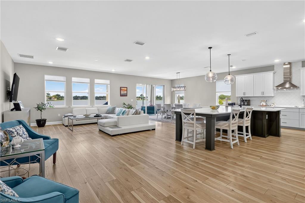 2082 Grove Drive Naples, FL 34120 - Photo 4 of 50 a living room with furniture kitchen view and a wooden floor