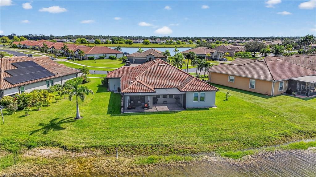 2082 Grove Drive Naples, FL 34120 - Photo 46 of 50 a view of a big house with a big yard and large trees