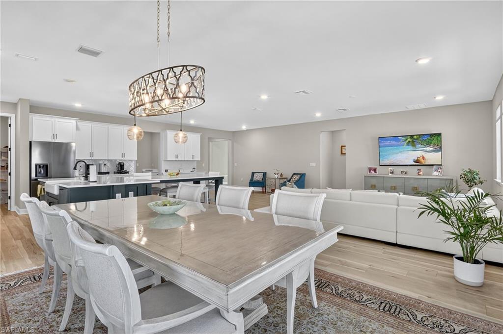 2082 Grove Drive Naples, FL 34120 - Photo 8 of 50 a view of a dining room with furniture window and wooden floor
