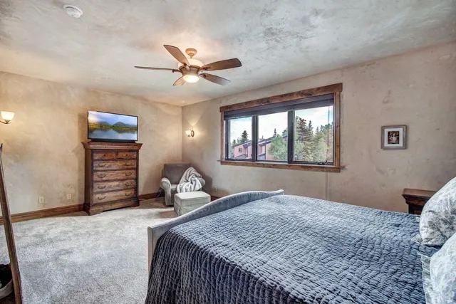 a bedroom with a large bed and a window