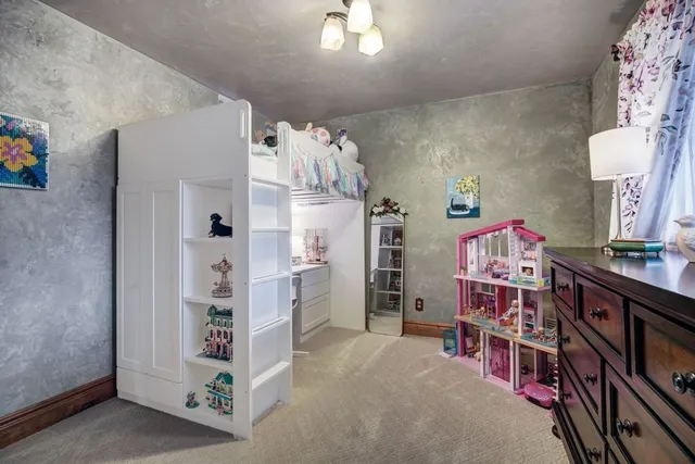 walk in closet with window and chandelier