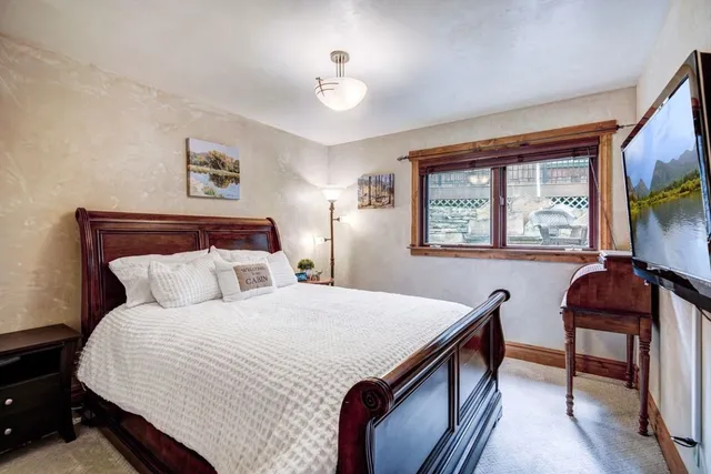 a bedroom with a bed and a desk