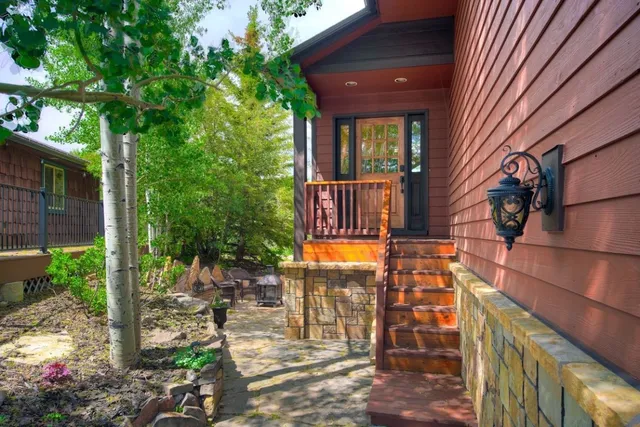 a view of a house with backyard and sitting area