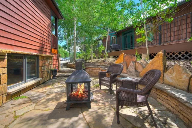 a view of a patio with table and chairs and potted plants
