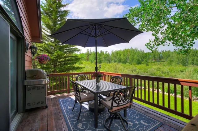 a view of balcony with furniture and umbrella