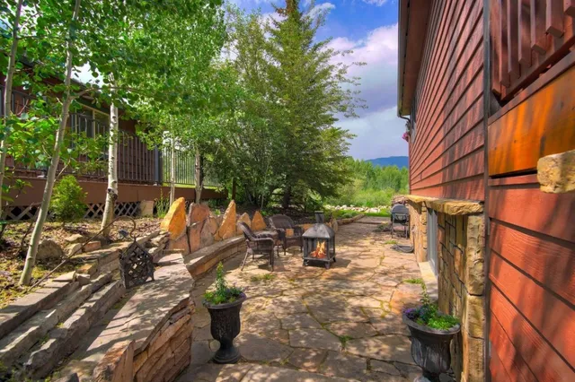 a view of a patio with table and chairs and potted plants