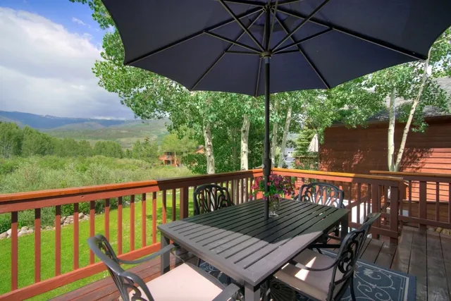 a view of a deck with furniture and wooden deck