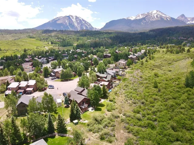 a view of mountains in middle of the green field