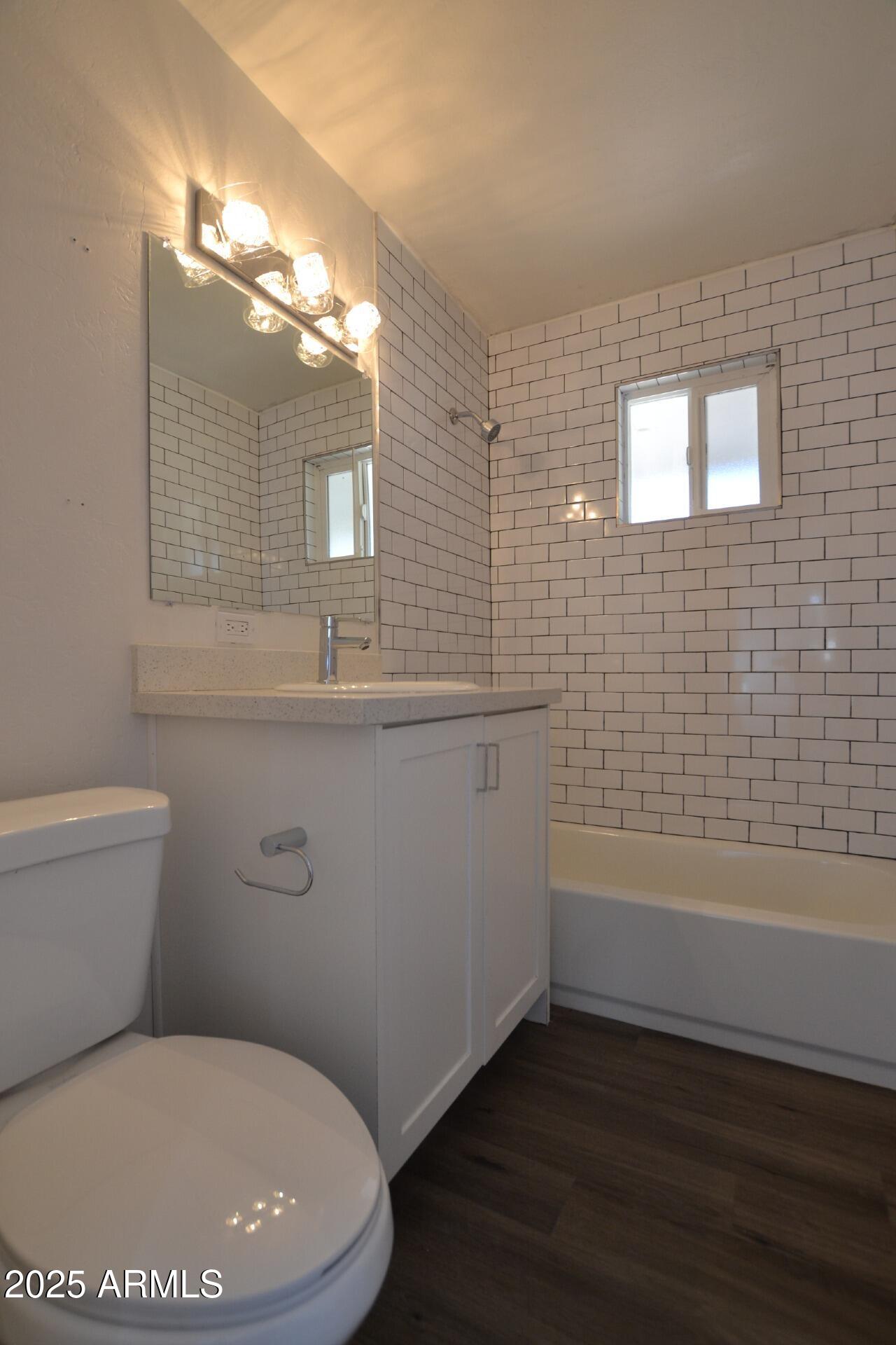 1202 East Kaler Drive, Unit 3 Phoenix, AZ 85020 - Photo 7 of 9 a bathroom with a toilet sink and mirror