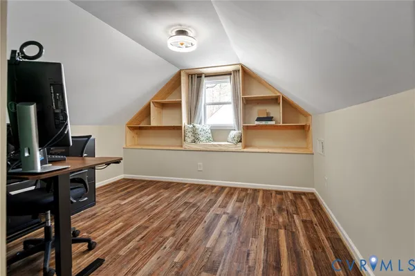 a view of a livingroom with wooden floor and a flat screen tv