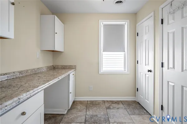 a view of a kitchen with granite countertop cabinets