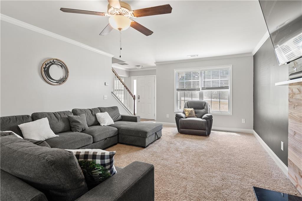 1117 Roxey Maxey Road Southwest Winder, GA 30680 - Photo 1 of 1 a living room with furniture and a window