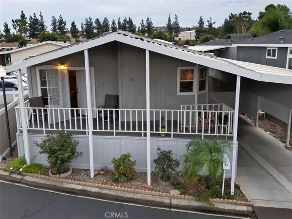 an aerial view of a house with a yard and potted plants
