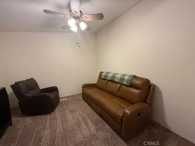 a white couch sitting in a living room with furniture
