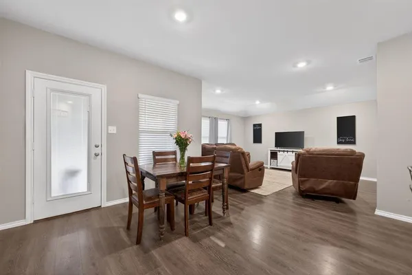a view of a dining room with furniture and wooden floor