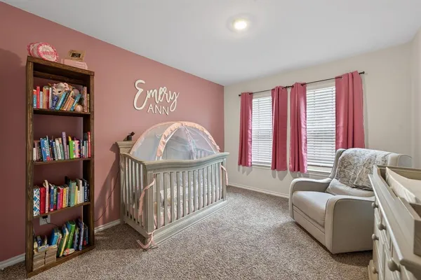 a bedroom with furniture and a book shelf