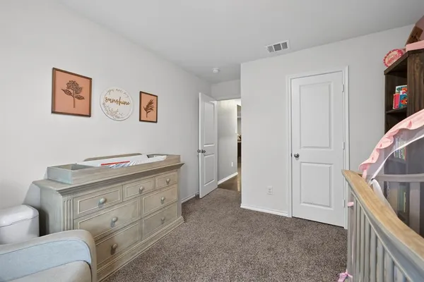a view of room with cabinet and hallway