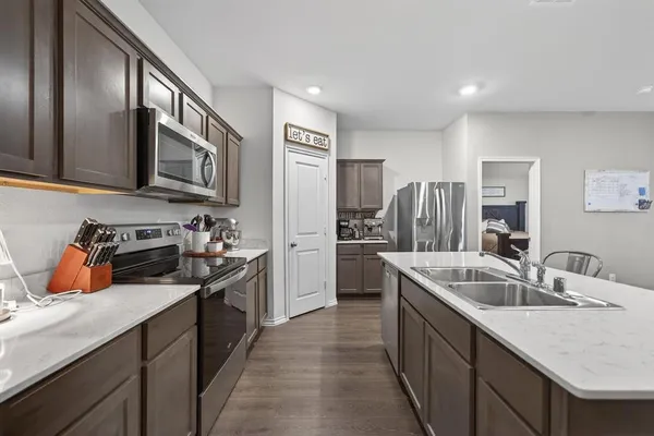 a kitchen with a sink stove and refrigerator