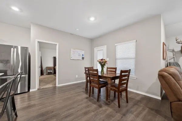 a view of a dining room with furniture and a window