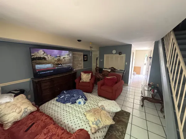 a bed room with furniture and a flat screen tv