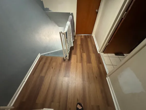 a view of wooden floor in hallway