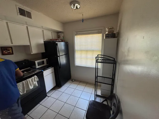 a kitchen with a refrigerator and a stove