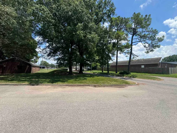 a view of a house with a big yard and large trees