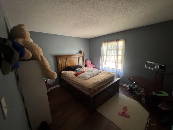 a bedroom with a bed and a potted plant