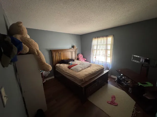 a bedroom with a bed and a potted plant