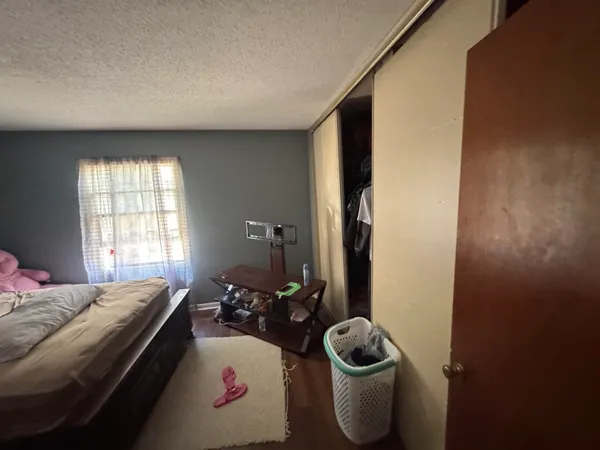 a bed room with a bed and a window