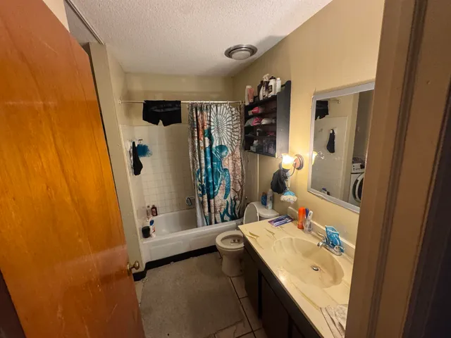 a bathroom with a sink a mirror and a bathtub